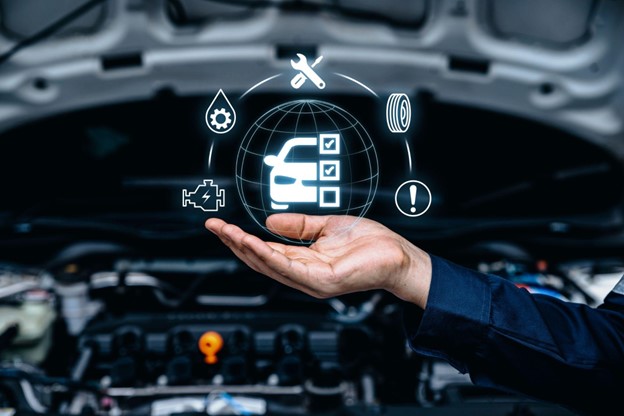 Mechanic hand supporting graphic of car warning lights in front of car engine